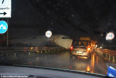 Photos: DHL Cargo plane slides off runway at Italian airport and crashes onto a busy road